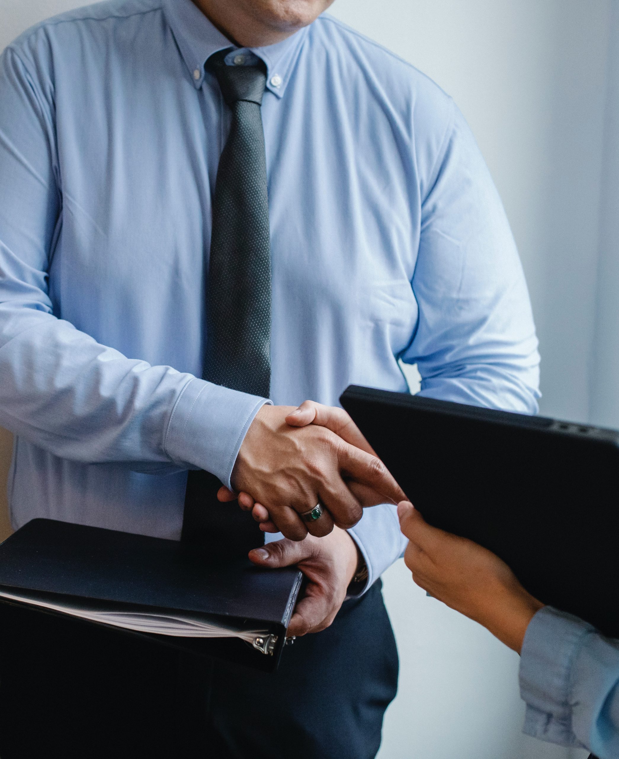 partial body shaking hands